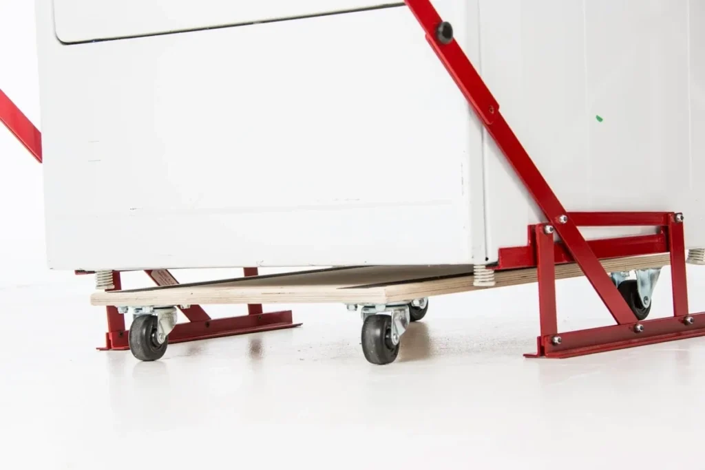 mechanic Close-up of the Simple Placeholder Product 1 on a red metal frame with caster wheels, set on a smooth white surface.
